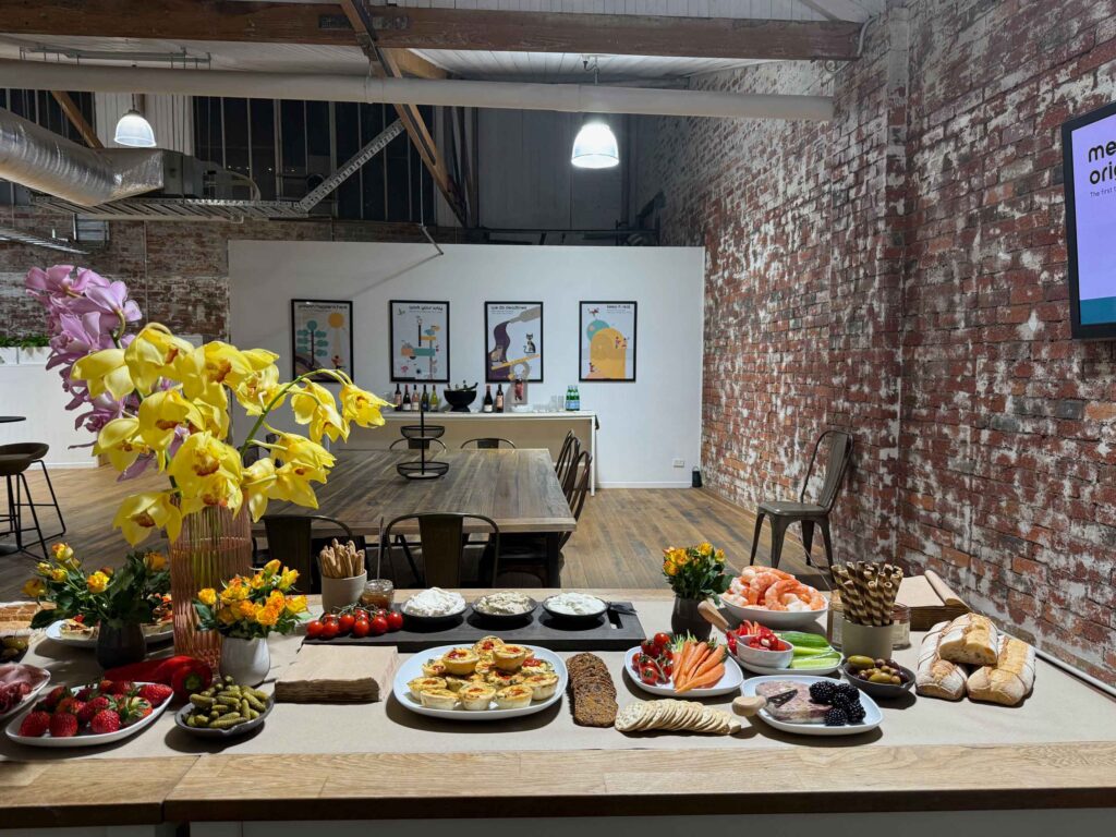 Grazing table at ko&co launch night with digitally illustrated brand artwork in the background